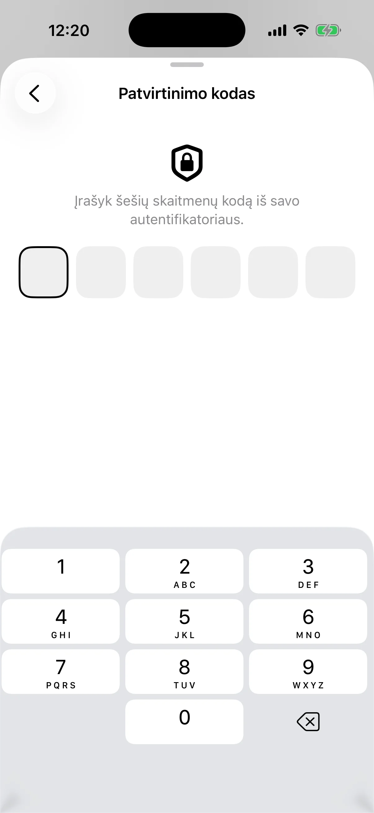 The two-factor step: six empty boxes for the code from an authenticator app, above a number pad