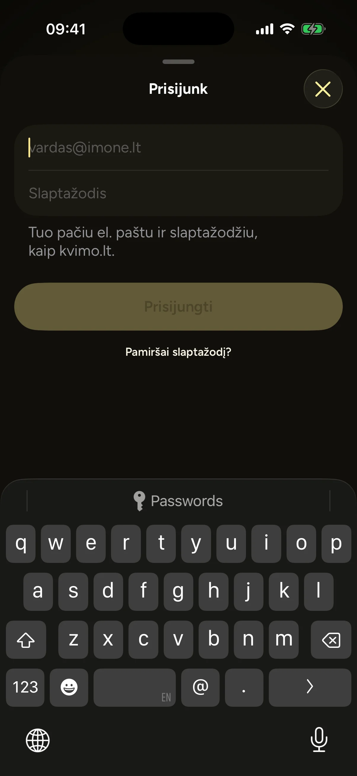 Sign-in sheet over the Kvimo welcome screen: email and password fields, a note to use the same email and password as kvimo.lt, and a forgotten password link