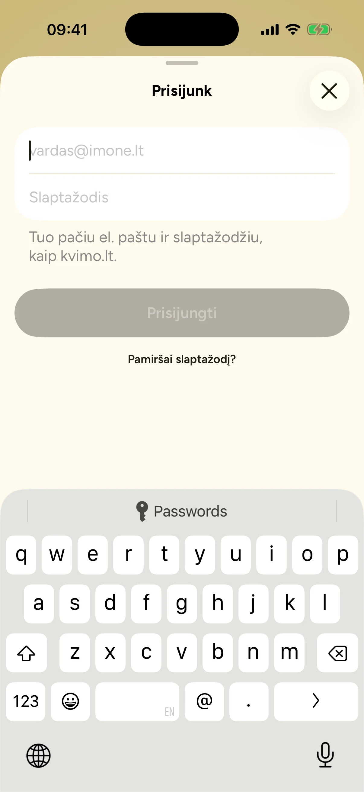 Sign-in sheet over the Kvimo welcome screen: email and password fields, a note to use the same email and password as kvimo.lt, and a forgotten password link